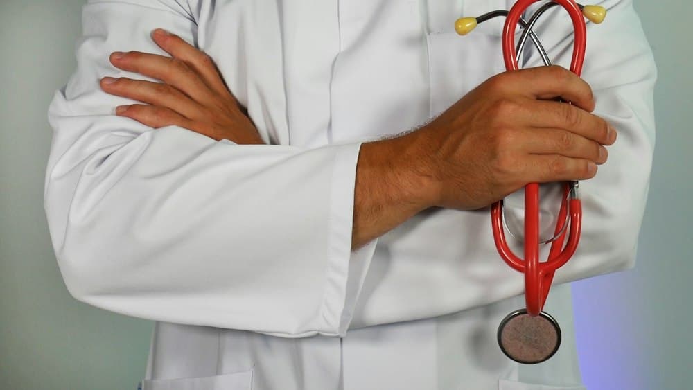 Nursing student performing bedside hospital clinical rotation with patient